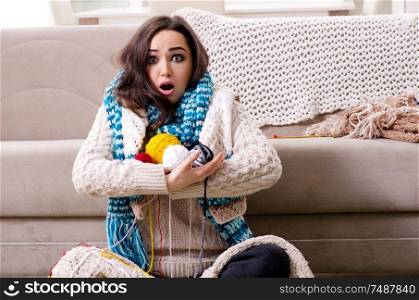 The young beautiful woman knitting at home. Young beautiful woman knitting at home