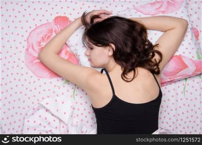 The young beautiful woman sleeping in bed