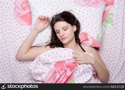 The young beautiful woman sleeping in bed