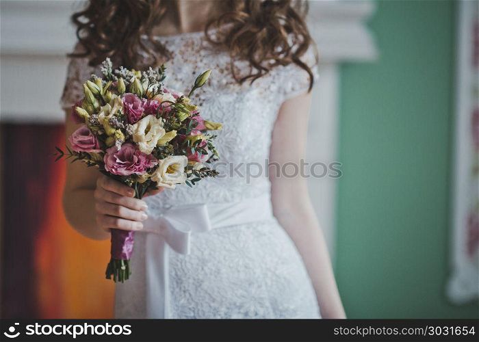 The young bride costs with a bunch of flowers.. Bunch of flowers in hands of the bride 2647.. Bunch of flowers in hands of the bride 2647.