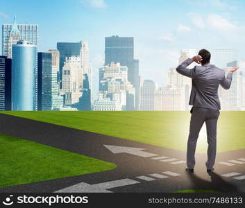 The young businessman at crossroads in uncertainty concept. Young businessman at crossroads in uncertainty concept