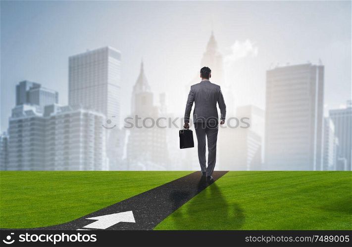 The young businessman at crossroads in uncertainty concept. Young businessman at crossroads in uncertainty concept