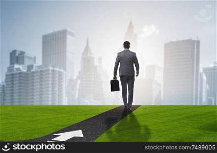 The young businessman at crossroads in uncertainty concept. Young businessman at crossroads in uncertainty concept