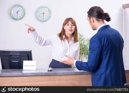 The young businessman at hotel reception. Young businessman at hotel reception