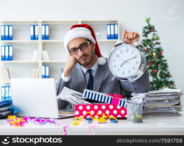 The young businessman celebrating christmas in the office. Young businessman celebrating christmas in the office