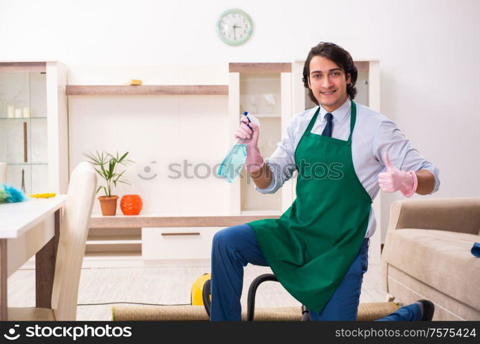 The young businessman cleaning the house. Young businessman cleaning the house