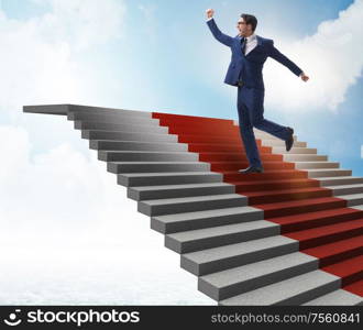 The young businessman climbing stairs and red carpet into sky. Young businessman climbing stairs and red carpet into sky