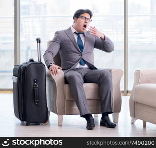 The young businessman in airport business lounge waiting for flight. Young businessman in airport business lounge waiting for flight