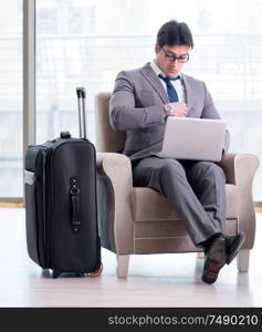 The young businessman in airport business lounge waiting for flight. Young businessman in airport business lounge waiting for flight