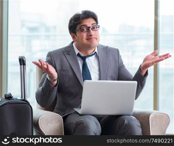 The young businessman in airport business lounge waiting for flight. Young businessman in airport business lounge waiting for flight