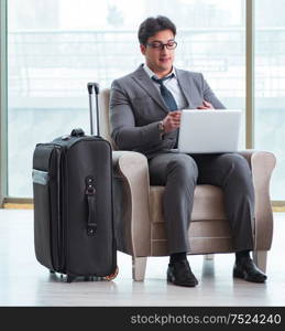 The young businessman in airport business lounge waiting for flight. Young businessman in airport business lounge waiting for flight