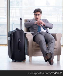 The young businessman in airport business lounge waiting for flight. Young businessman in airport business lounge waiting for flight