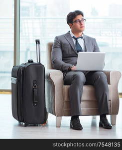 The young businessman in airport business lounge waiting for flight. Young businessman in airport business lounge waiting for flight