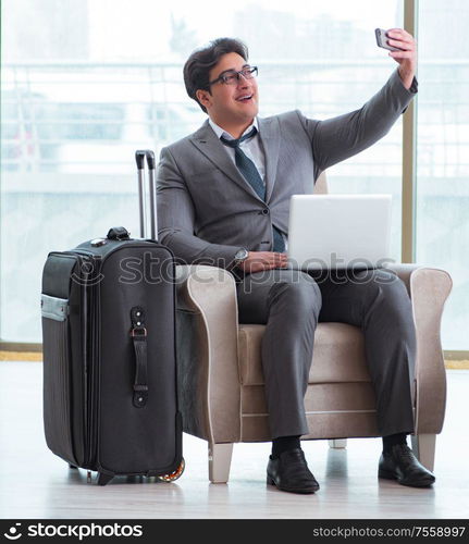 The young businessman in airport business lounge waiting for flight. Young businessman in airport business lounge waiting for flight