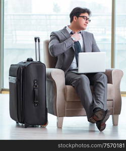 The young businessman in airport business lounge waiting for flight. Young businessman in airport business lounge waiting for flight