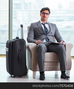 The young businessman in airport business lounge waiting for flight. Young businessman in airport business lounge waiting for flight