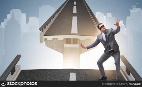 The young businessman in uncertainty concept with bridge. Young businessman in uncertainty concept with bridge