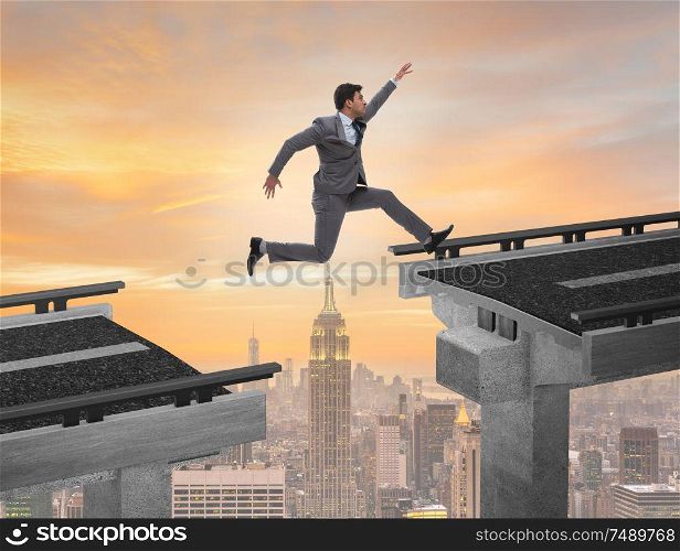 The young businessman jumping over the bridge. Young businessman jumping over the bridge
