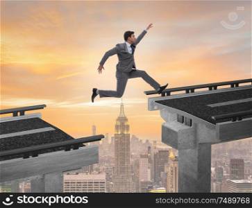 The young businessman jumping over the bridge. Young businessman jumping over the bridge