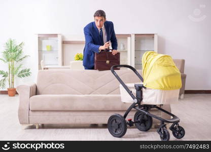 The young businessman looking after baby. Young businessman looking after baby