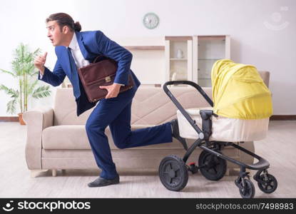 The young businessman looking after baby. Young businessman looking after baby