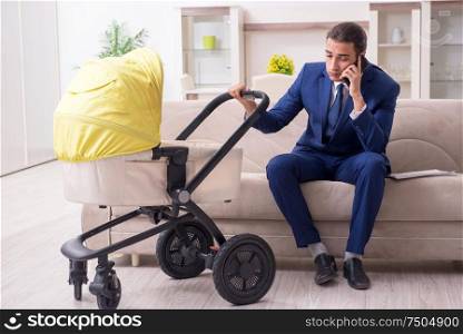 The young businessman looking after baby. Young businessman looking after baby