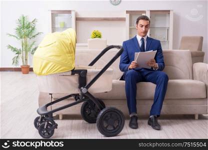 The young businessman looking after baby. Young businessman looking after baby