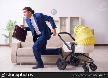 The young businessman looking after baby. Young businessman looking after baby