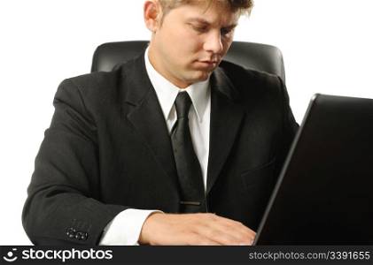 The young businessman on a workplace. It is isolated on a white background