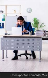 The young businessman sitting and working in the office. Young businessman sitting and working in the office