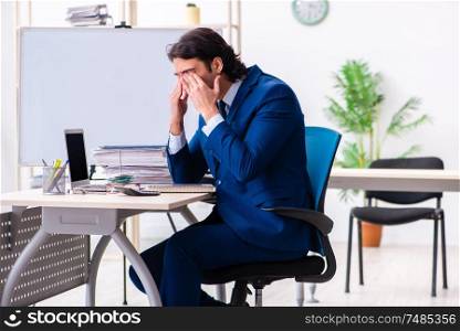 The young businessman sitting and working in the office. Young businessman sitting and working in the office