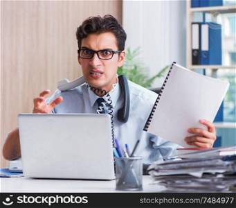 The young businessman under pressure in office to deliver tasks. Young businessman under pressure in office to deliver tasks