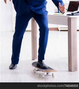 The young businessman with skate in office in sports concept. Young businessman with skate in office in sports concept