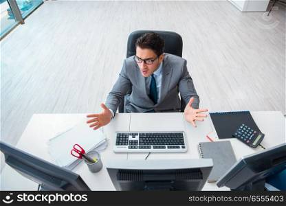 The young businessman working at his desk. Young businessman working at his desk