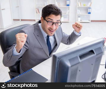 The young businessman working at his desk. Young businessman working at his desk