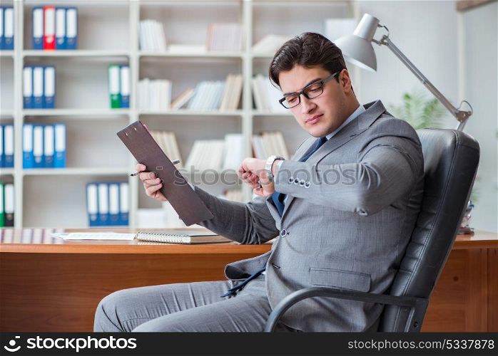 The young businessman working in the office. Young businessman working in the office