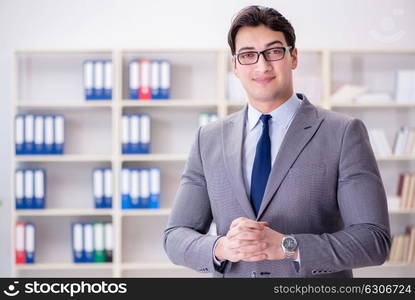 The young businessman working in the office. Young businessman working in the office