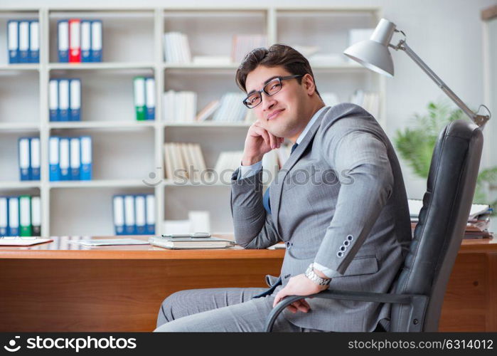 The young businessman working in the office. Young businessman working in the office