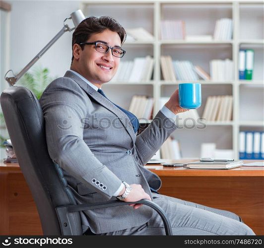 The young businessman working in the office. Young businessman working in the office