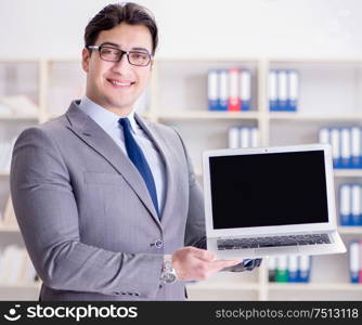 The young businessman working in the office. Young businessman working in the office