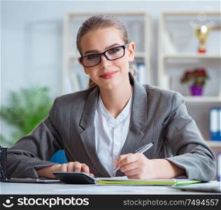 The young businesswoman accountant working in the office. Young businesswoman accountant working in the office