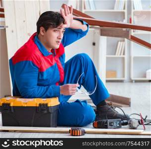 The young carpenter at work tired feeling not well. Young carpenter at work tired feeling not well