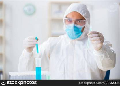 The young chemist student working in lab on chemicals. Young chemist student working in lab on chemicals
