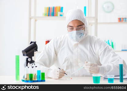 The young chemist student working in lab on chemicals. Young chemist student working in lab on chemicals