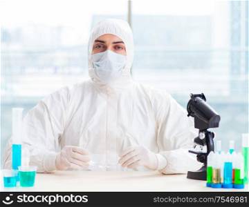 The young chemist student working in lab on chemicals. Young chemist student working in lab on chemicals