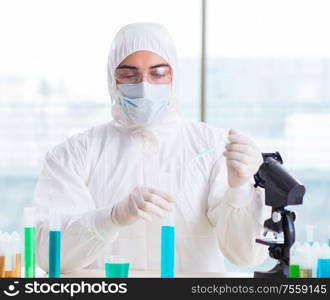 The young chemist student working in lab on chemicals. Young chemist student working in lab on chemicals