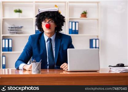 The young clown businessman working in the office. Young clown businessman working in the office