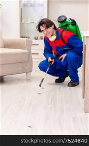 The young contractor doing pest control at home. Young contractor doing pest control at home