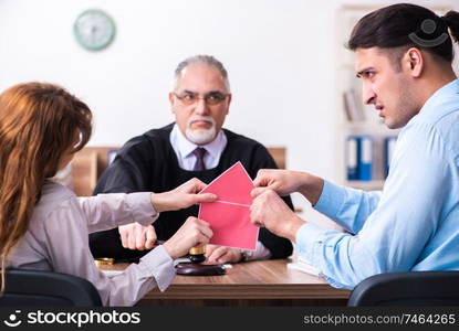 The young couple in the courthouse in divorce concept  . Young couple in the courthouse in divorce concept  