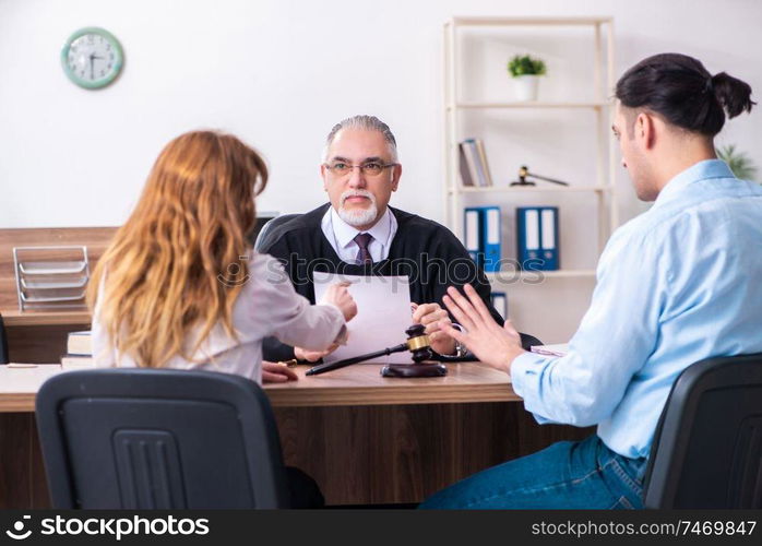 The young couple in the courthouse in divorce concept  . Young couple in the courthouse in divorce concept  